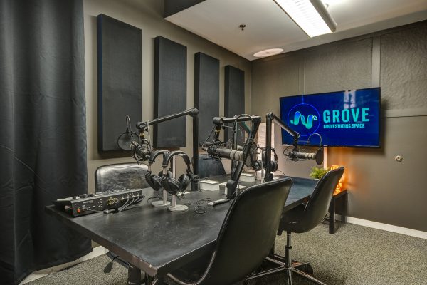 Podcast studio with Microphones, Headphones, TV, and chairs