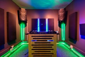 DJ Studio featuring Pioneer CDJs, color changing lights, automated recording, live-streaming capabilities, and microphones.