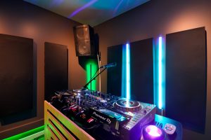 DJ Studio featuring Pioneer CDJs, color changing lights, automated recording, live-streaming capabilities, and microphones.