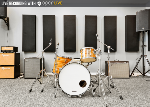 Fully backlined music practice and band rehearsal studio with drumset, amps, PA system, and sound treatment